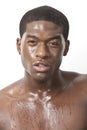 Portrait of young African American man sweating over white background Royalty Free Stock Photo