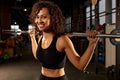 Portrait of young african american woman lifting barbell while exercising in crossfit gym. Self-motivation, keep the Royalty Free Stock Photo