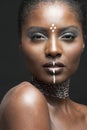 Portrait of young african american woman with traditional white paint on face