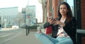 Portrait of young African American woman using phone, outdoors.