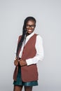 Portrait of happy young african business woman wearing glasses standing looking camera over grey background Royalty Free Stock Photo