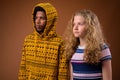 Portrait of young African man and Caucasian teenage girl thinking Royalty Free Stock Photo