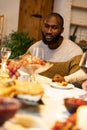 Portrait of young african man celebrates with friends happy Thanksgiving day. Concept of holiday, love, care Royalty Free Stock Photo