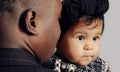 Portrait of young african man holding on arms his baby daughter from interracial marriage