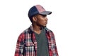 Portrait young african man looking away wearing a baseball cap, red plaid shirt isolated on a white background Royalty Free Stock Photo