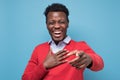 Portrait of a young african man pointing his finger at you and laughing Royalty Free Stock Photo