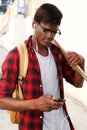Young african man with skateboard looking at mobile phone Royalty Free Stock Photo
