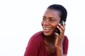 Young african woman making a phone call looking over shoulder and smiling on white background Royalty Free Stock Photo