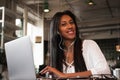 portrait of young african woman relaxing in cafe with laptop an Royalty Free Stock Photo