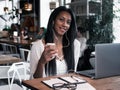 portrait of young african woman relaxing in cafe with laptop an Royalty Free Stock Photo