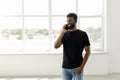 Portrait of young afro man at home making a phone call Royalty Free Stock Photo