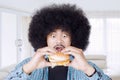 Young man eating a big cheeseburger Royalty Free Stock Photo