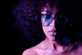 Portrait of young alluring mixed race girl in neon light. Fashion, glamour, model concept. Seductive woman with make-up Royalty Free Stock Photo