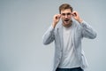 Portrait of young amazed man isolated on gray background. Royalty Free Stock Photo