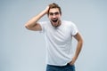 Portrait of young amazed man isolated on gray background. Royalty Free Stock Photo