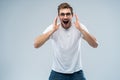 Portrait of young amazed man isolated on gray background. Royalty Free Stock Photo