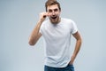 Portrait of young amazed man isolated on gray background. Royalty Free Stock Photo