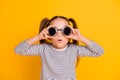 Portrait of young amazed surprised impressed little girl kid child wear funky round sunglasses on yellow color