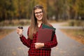 Portrait of young american university student smiling with takeaway coffee