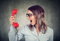 Portrait of a young angry woman yelling at the phone Royalty Free Stock Photo