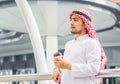 Portrait of Young Arab middle eastern man standing enjoy with coffee in his hand outdoor city view background Royalty Free Stock Photo