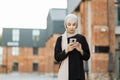 Portrait of young arabian businesswoman using mobile phone in city. Royalty Free Stock Photo