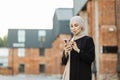 Portrait of young arabian businesswoman using mobile phone in city. Royalty Free Stock Photo