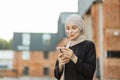 Portrait of young arabian businesswoman using mobile phone in city. Royalty Free Stock Photo