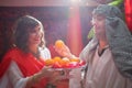 Portrait of young arabian muslim couple in traditional clothes in cozy red room. Fhoto shoot in easten style with male