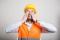 Portrait of young architect covering eyes like not seeing