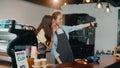 Portrait young Asia female barista feeling happy with friend at urban cafe. Small business owner Korean girl in apron taking Royalty Free Stock Photo