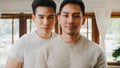 Portrait Young Asia Gay couple feeling happy smiling at home. Asian LGBTQ men relax toothy smile looking to camera while hug in Royalty Free Stock Photo