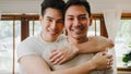 Portrait Young Asia Gay couple feeling happy smiling at home. Asian LGBTQ men relax toothy smile looking to camera while hug in Royalty Free Stock Photo