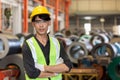 Portrait of Young Asia man engineer yellow helmet in uniform standing at industrial space. male worker large industrial factory