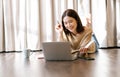 Portrait of young Asian beautiful woman freelancer working at home  lying in comfortable living room using modern laptop computer Royalty Free Stock Photo