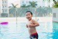 Portrait of Young asian boy kid child laughing in a swimming pool. Sunlight filter process Royalty Free Stock Photo