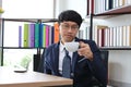 Portrait of young Asian business man in formal suit drinking coffee in office Royalty Free Stock Photo