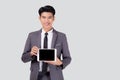 Portrait young asian business man showing and presenting tablet computer with blank with success isolated on white background Royalty Free Stock Photo