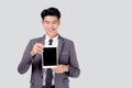 Portrait young asian business man showing and presenting tablet computer with blank with success isolated. Royalty Free Stock Photo