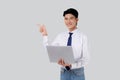 Portrait young asian business man standing work on laptop computer to internet online isolated white background. Royalty Free Stock Photo