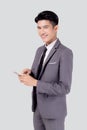 Portrait young asian business man in suit standing using smartphone to internet isolated on white background. Royalty Free Stock Photo