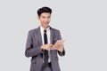 Portrait young asian business man in suit standing using tablet computer to internet isolated on white background. Royalty Free Stock Photo