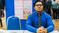 A portrait of a young Asian business man wearing a blue shirt shirt, black necktie and spectacles Royalty Free Stock Photo