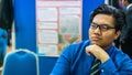 A portrait of a young Asian business man wearing a blue shirt shirt, black necktie and spectacles Royalty Free Stock Photo