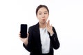 Portrait young asian business woman showing and presenting smartphone with blank with mockup isolated. Royalty Free Stock Photo