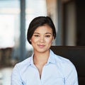 Portrait, young and Asian business woman working in a modern office and smiling. Happy, confident and female Royalty Free Stock Photo