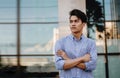 Portrait of a Young Asian Businessman in the City. Crossed Arms and looking away Royalty Free Stock Photo