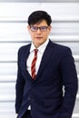 Portrait of young Asian businessman look at camera. Successful business man standing wearing suit on white background Royalty Free Stock Photo