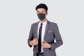 Portrait young asian businessman in suit confident wearing face mask for protective covid-19 isolated on white background. Royalty Free Stock Photo