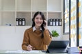 Portrait young asian businesswoman beautiful charming smiling and talking on the mobile phone in the office. Royalty Free Stock Photo